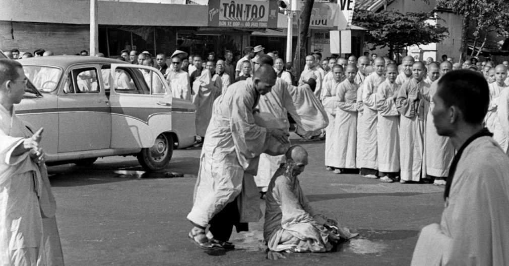 Buddhist monk Quang Duc sitting in the center of the intersection while a younger monk poured gasoline over him. June 11 1963 Malcolm Browne